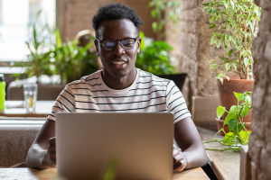 black-man-student-watching-educational-webinar-on-laptop